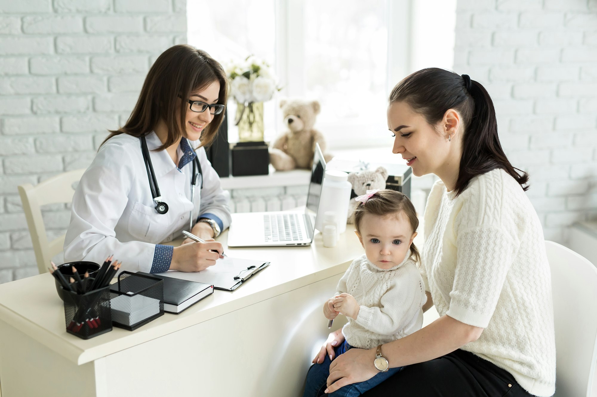 Pediatrician Meeting With Mother And Child In Hospital